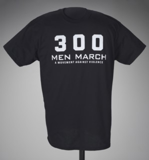 Black t-shirt for 300 Men March worn at a rally after the death of Freddie Gray, 2015. Creator: Gildan Activewear Inc..