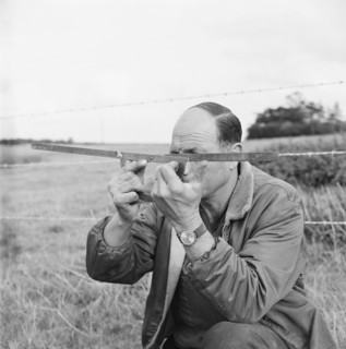 A man holding a surveyor's protractor working on the route of the Mersey oil pipeline, 24/09/1967. Creator: John Laing plc.