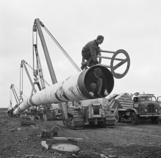 The Fens gas pipeline being lifted by a row of Caterpillar 583 pipelayers, Norfolk, 20/09/1967. Creator: John Laing plc.