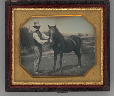 Untitled (Portrait of a Man Wearing a Top Hat Standing Next to a Horse), 1850s. Creator: Unknown.