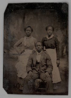 Untitled (Portrait of Two Standing Women and One Seated Man), 1880. Creator: Unknown.
