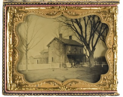 Two and a Half Story Brick Country House with Outbuildings with Ornate Porch..., 19th century. Creator: Unknown.