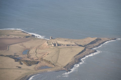 Remains of the 14th century Dunstanburgh Castle, Northumberland, 2015. Creator: Historic England.
