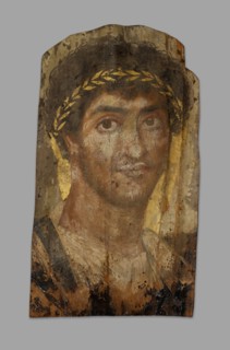 Mummy Portrait of a Man Wearing a Laurel Wreath, Fayum, Early to mid-2nd century. Creator: Unknown.