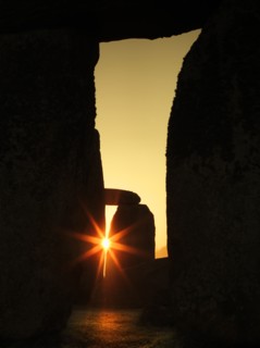 View of Stonehenge, showing the sun's rays glinting through the opening in a trilithon, 2012. Creator: James O Davies.