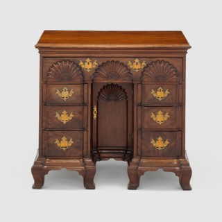 Bureau Table, c. 1770. Small wooden bureau with carved half-circle designs, gilded handles. Attributed to John Townsend.