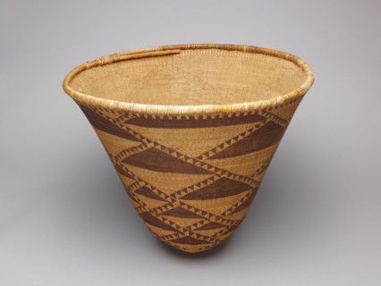 Burden Basket, 1870/80. Large tan woven basket with dark brown triangles.