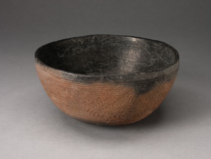 Bowl with Textured Surface Decoration in Basketry-Like Pattern, A.D. 900/1000. Round, red-brown bowl with small cracks its black interior. The outer surface is striated with tight horizontal lines and...