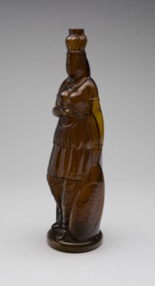 Bottle, 1867/75. Bottle in the shape of a Native American woman, known as the 'Indian Queen' design. Inscribed 'Brown's Celebrated Indian Herb Bitters'. Possibly made by Whitney Brothers Glass Works.