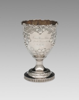 Goblet, 1852. Relief decoration of grapes and vine leaves, inscribed: 'James Brown Potter, from his Grandmother E.M.B.'.
