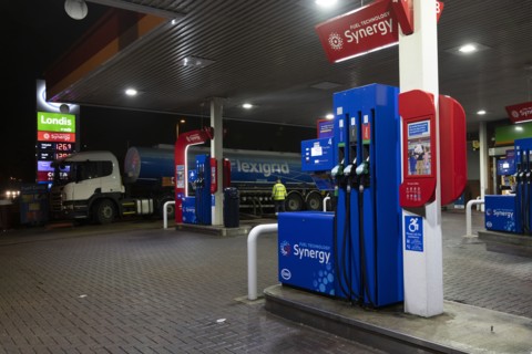 Esso petrol station forecourt with tanker delivering fuel, 2020.