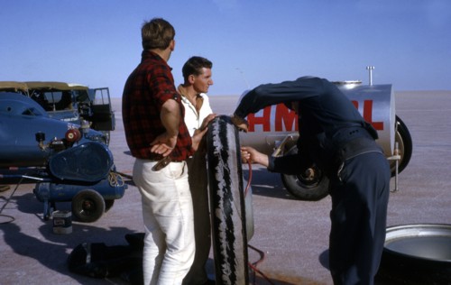 Mechanics inflating Bluebird CN7 tyre for World Land Speed Record attempt, Lake Eyre, 1964. Creator: Unknown.