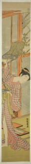 Young Woman Hanging a Painting, c. 1771. Creator: Isoda Koryusai.