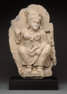 Goddess Hariti Seated Holding a Child, 2nd/3rd century. Ancient region of Gandhara (modern Pakistan).