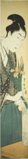Young man arranging irises in a vase, n.d.
