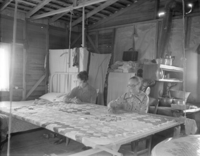 Grandmother from Oklahoma with grandson, working on quilt, California, Kern County, 1936. Creator: Dorothea Lange.