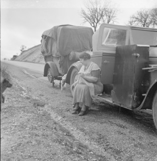 Migrant pea workers on the road, all their worldly possessions in car and trailer, California, 1936. Creator: Dorothea Lange.