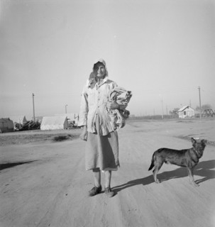 Cotton picker on her way to the cotton field, Kern migrant camp, California, 1936. Creator: Dorothea Lange.