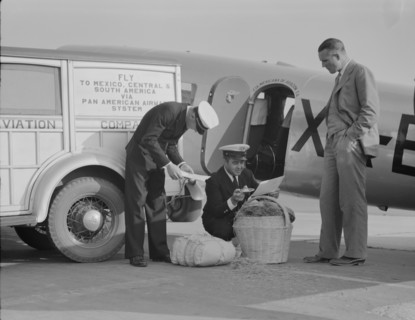 Plant quarantine inspectors examining baggage from Mexico, Glendale Airport, California, 1937. Creator: Dorothea Lange.