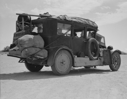 Family...from Fort Smith, Arkansas, trying to repair their car..., Arizona, 1937. Creator: Dorothea Lange.