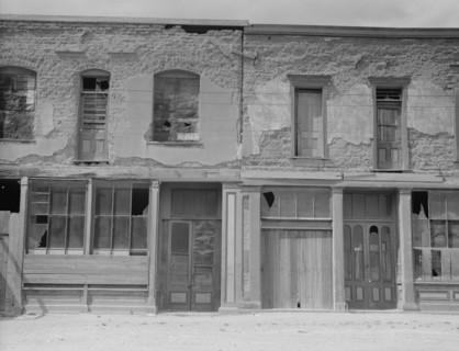 Crumbling buildings in Tombstone, Arizona, once a thriving mining town, 1937. Creator: Dorothea Lange.