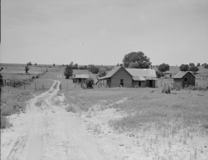 Worn-out land and abandoned cabins near Newport, Oklahoma, 1937. Creator: Dorothea Lange.