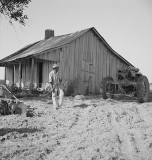 Colored tractor driver and empty cabin, Aldridge Plantation near Leland, Mississippi, 1937. Creator: Dorothea Lange.