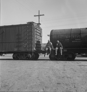 Colored itinerants on oil tank cars passing through Kingsbury, California, 1938. Creator: Dorothea Lange.