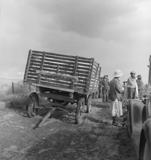 Migratory cotton pickers have stopped working because it started to rain, Kern County, CA, 1938. Creator: Dorothea Lange.