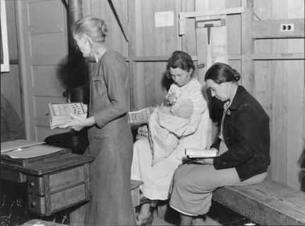 Hymn singing at meeting of Mothers' Club in Arvin migrant camp, California, 1938. Creator: Dorothea Lange.