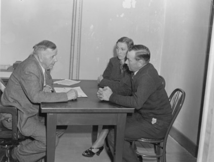 Night meeting in the FSA office, Visalia, Tulare County, California, 1938. Creator: Dorothea Lange.