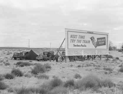Billboard along U.S. 99...three destitute families...Kern County, CA, 1938. Creator: Dorothea Lange.