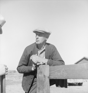 Rehabilitation client talking over fence with county supervisor, near Stockton, CA, 1938. Creator: Dorothea Lange.