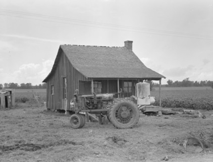 Tractors with pneumatic tires are replacing mules on the Delta plantations, Arkansas, 1939. Creator: Dorothea Lange.