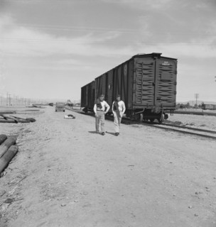 Car on siding across tracks from pea packing plant, Calipatria, Imperial Valley, 1939. Creator: Dorothea Lange.