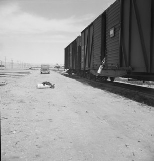 Car on siding across tracks from pea packing plant, Calipatria, Imperial Valley, 1939. Creator: Dorothea Lange.