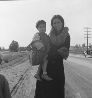 Homeless mother and youngest child of seven...on U.S. 99, near Brawley, Imperial County, 1939. Creator: Dorothea Lange.