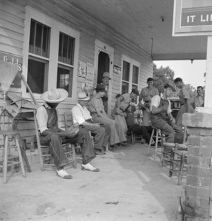 Rural filling station becomes community center...for loafing, near Chapel Hill, North Carolina, 1939 Creator: Dorothea Lange.
