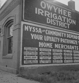 Sign on old bank building which now houses office of Bureau..., Nyssa, Malheur County, Oregon, 1939. Creator: Dorothea Lange.