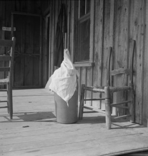 Pottery butter churn on porch of Negro tenant family, Randolph County, North Carolina, 1939. Creator: Dorothea Lange.