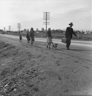 Homeless family of seven, walking the highway..., on U.S. 99, near Brawley, Imperial County, 1939. Creator: Dorothea Lange.