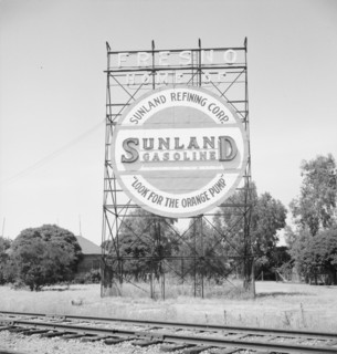 Illuminated sign, approaching San Joaquin Valley town, outskirts of Fresno, on U.S. 99, CA, 1939. Creator: Dorothea Lange.
