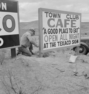 New sign along highway advertises a new enterprise in the lonely town of Maupin, Oregon, 1939. Creator: Dorothea Lange.