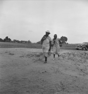 Mother of sharecropper family and friend...in the rain, Person County, North Carolina, 1939. Creator: Dorothea Lange.