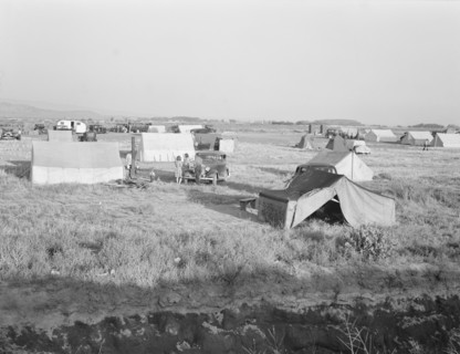Families camped on flat before season opens waiting..., near Merrill, Klamath County, Oregon, 1939. Creator: Dorothea Lange.