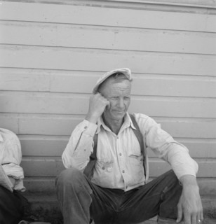 Bindle stiff, used to be logger, Side of Pastime Café, Tulelake, Siskiyou County, California, 1939. Creator: Dorothea Lange.