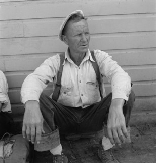 Bindle stiff, used to be logger, Side of Pastime Café, Tulelake, Siskiyou County, California, 1939. Creator: Dorothea Lange.