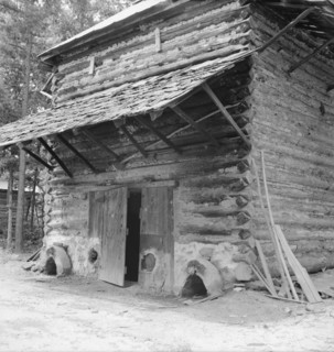 Tobacco barn with newly plastered furnace..., Person County, North Carolina, 1939. Creator: Dorothea Lange.