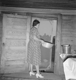Tobacco sharecropper's wife disposing of dishwater..., Person County, North Carolina, 1939. Creator: Dorothea Lange.