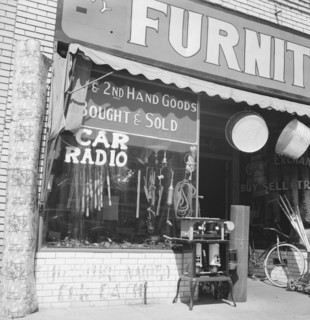 Storefront of San Joaquin Valley town, Fresno, on U.S. 99, California, 1939. Creator: Dorothea Lange.